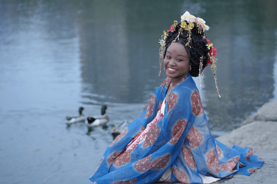 Nala Meite wearing traditional Chinese clothing by the water in Wuhan.