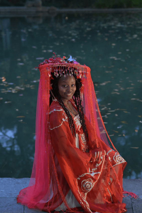 Nala Meite wearing red traditional Chinese clothing at West Lake in Hangzhou.