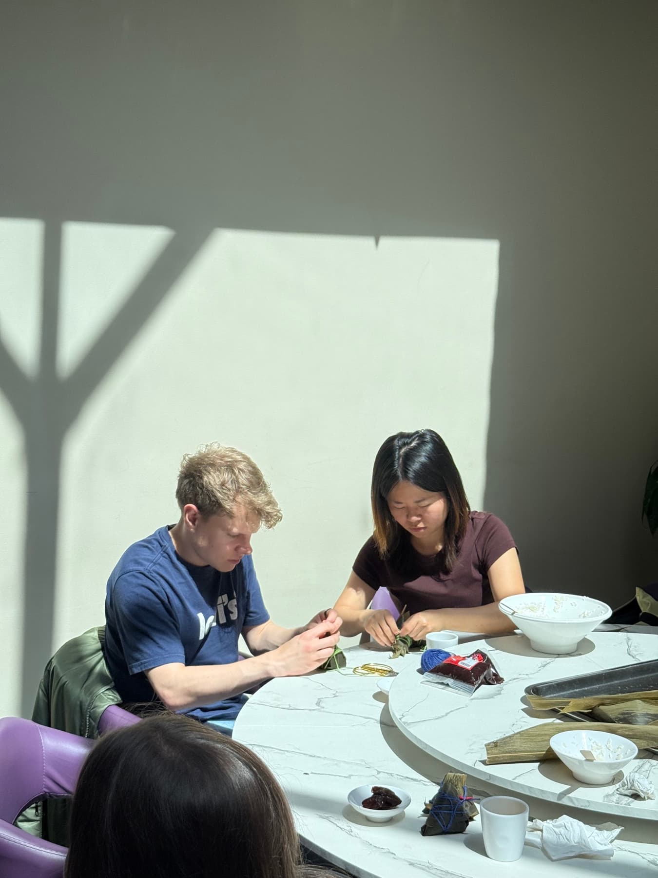 Participants learning to wrap zongzi during a Chinese cultural workshop in London