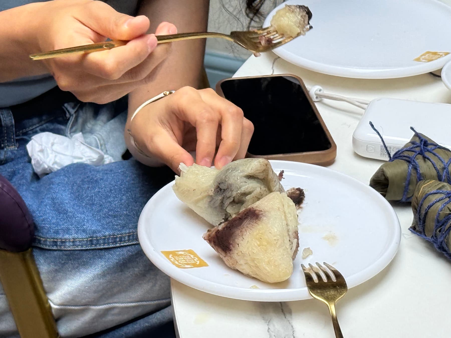 Steamed zongzi cut open to show sticky rice and red date filling