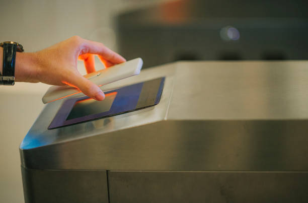 Phone being scanned at a station gate